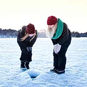 Two women ice fishing