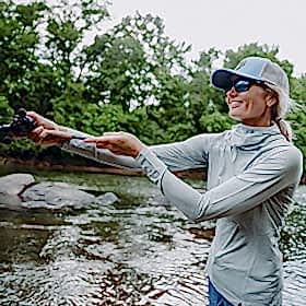 Woman fishing in shallow water
