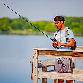 young man fishing from a dock