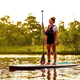 Woman standing on paddle board