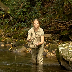 Young woman fly fishing