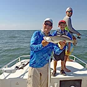 Two man and a child on boat fishing