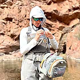 Woman tying a fly for fly fishing