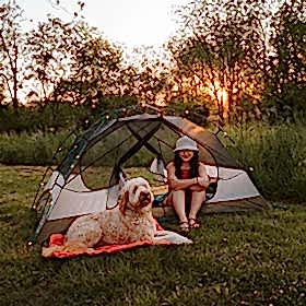 Young woman camping with her dog