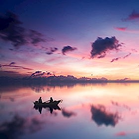 People on boat at sunset