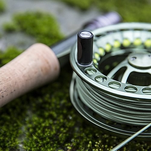 A person holding a fishing rod and fishing line