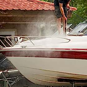 man cleaning a boat